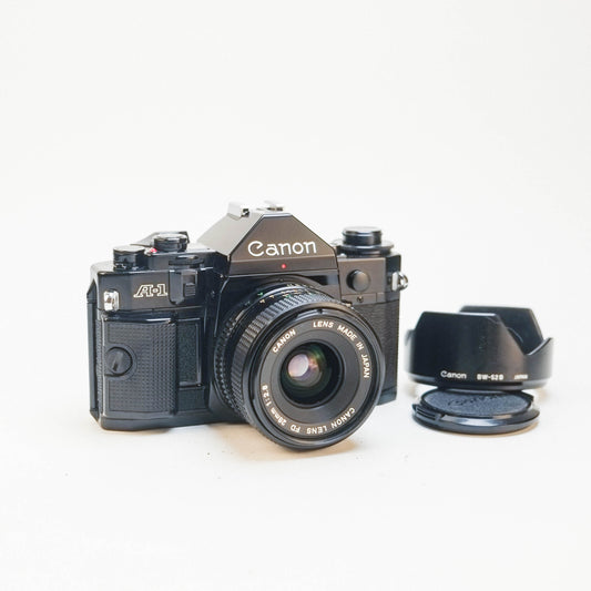 Canon A1 /w 28mm f2.8 FDn & Canon BW-52B lens hood [35mm kit]